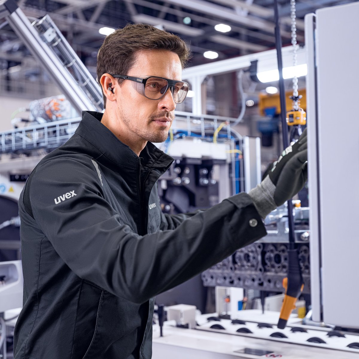 A man working while wearing uvex safety glasses